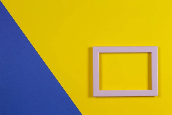 Abstract blue and yellow paper background with empty picture frame