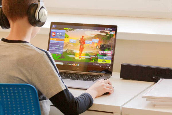Vilnius, Lithuania - March 2, 2019: Child playing Fortnite game. Fortnite is popular online video game developed by Epic Games
