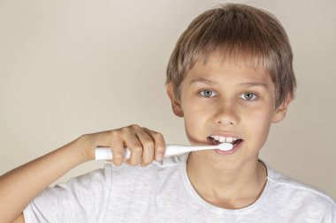 Beyaz elektrikli diş fırçası ile diş fırçalama çocuk