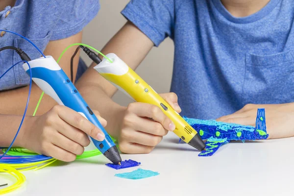 Zwei Kinderhände erstellen mit 3D-Druckstiften — Stockfoto