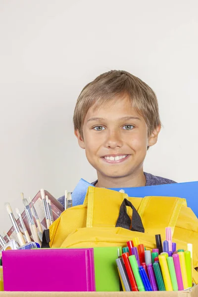 Concetto di donazione. Kid holding donare scatola con libri, matite e materiale scolastico — Foto Stock