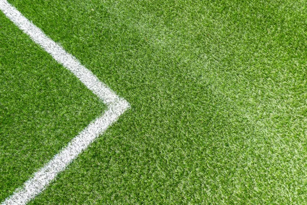 Green synthetic artificial grass soccer sports field with white corner stripe line — Stock Photo, Image