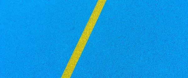 Colorful sports court banner background. Top view blue field rubber ground with white line outdoors