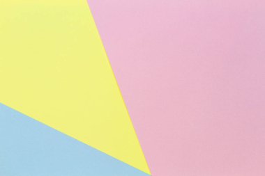 Soyut geometrik şekil pastel sarı, pembe ve mavi renkli kağıt arka plan
