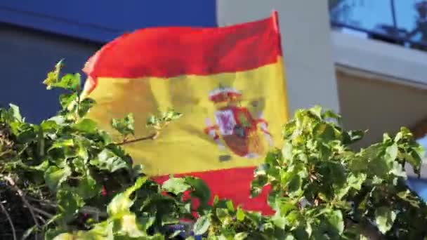 Bandera de España ondeando por el viento cerca de edificio de apartamentos residenciales en España — Vídeo de stock