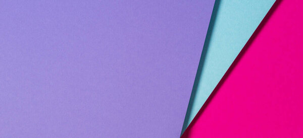 Abstract color papers geometry flat lay composition banner background with purple, blue and magenta color tones