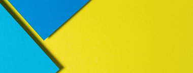 Soyut renk kağıtları geometri düz kompozisyon arka planı mavi ve sarı tonlarla