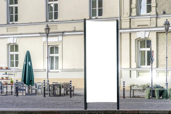 Mockup of blank white city outdoor advertising vertical billboard stand in old town street — Stock Photo, Image