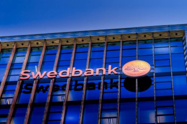 Vilnius, Lithuania- 16 September 2020: Swedbank logo on Swedbank office wall. Swedbank is the leading bank in Sweden Estonia Latvia and Lithuania clipart
