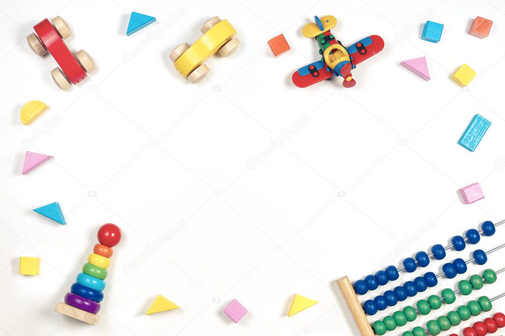 Colorful wooden baby kid toys frame on white background. Top view, flat lay. Copy space for text