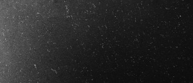 Dark scratched grunge texture background. Vintage black background with dust and scratches.