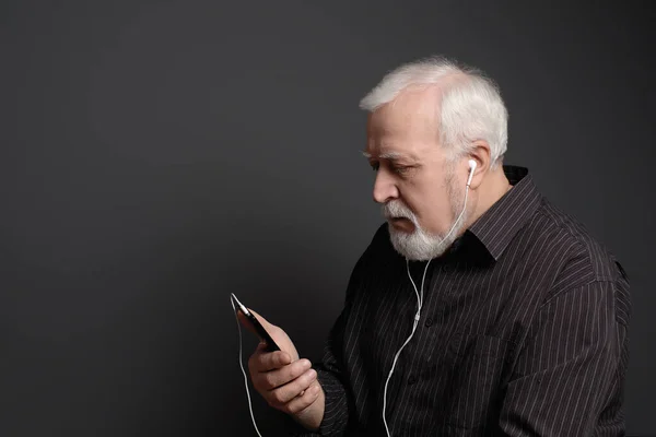 serious man with headphones and phone