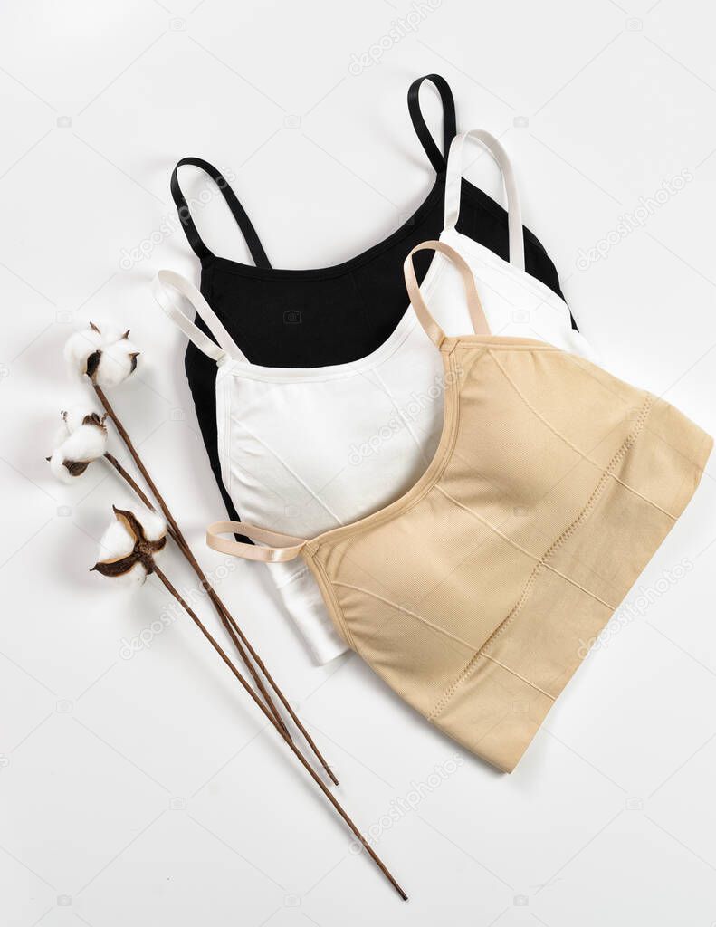 Sports bra for women. Sports bra for training. Black, white, beige sports bra on a white background, layout