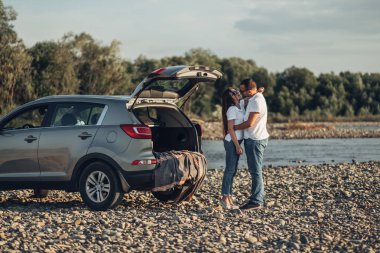 Mutlu çift Roadtrip Suv arabada batımına üzerinde