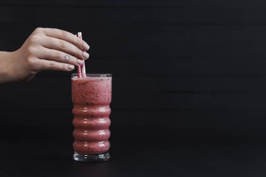 Bir Kırmızı Çilek Smoothie Kokteyli Kara Masa 'da duruyor.