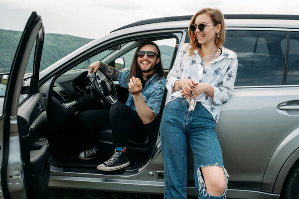 Two Young and Trendy Traveling Hipsters Having Fun Enjoying Road Trip Travel Concept