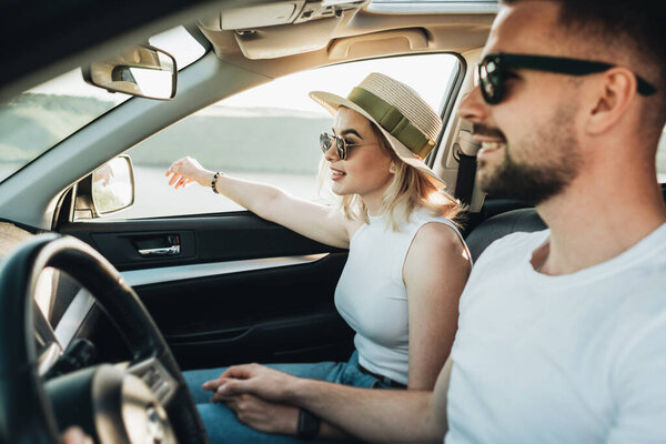 Happy Young Couple Sitting Inside Their Car Enjoying Road Trip, Travel and Adventure Concept