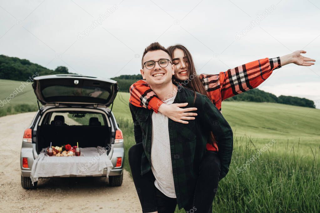 Young Beautiful Couple Having Fun Near Car, Travel and Roadtrip Concept