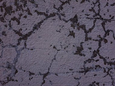 Arka plan alçı. Çimento duvar doku çatlaklar. Eski duvar.