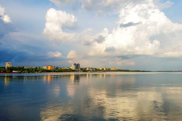 View on sity Zaporizhzhya, clouds on sky and river. The landscape is slightly blurred. Summer in Ukraine.
