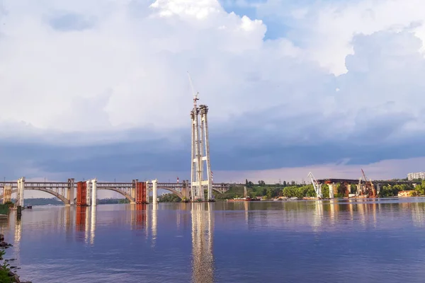 the construction of a bridge in Zaporizhia, a golden glow - the effect before a thunderstorm