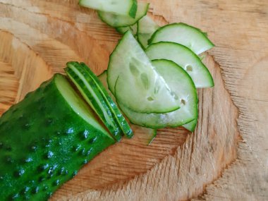 Tahta masada doğranmış yeşil salatalık.