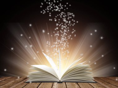 Siyah arka plan üzerine açık kitap parlak ışık ile