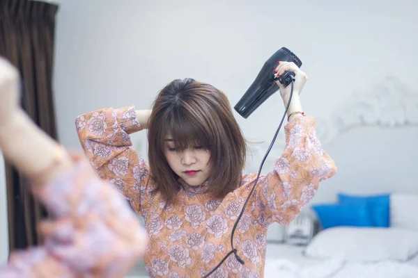 asian beauty woman hair dryer to drying hair after shower