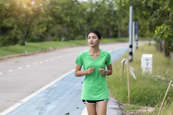 Asian women running in evening — Stock Photo, Image