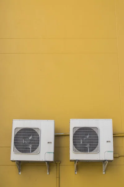 Air conditioning compressor on the yellow wall background