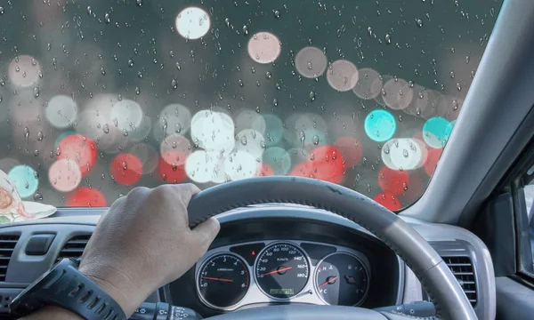 driver on a cloudy and rainy day In a city with heavy traffic