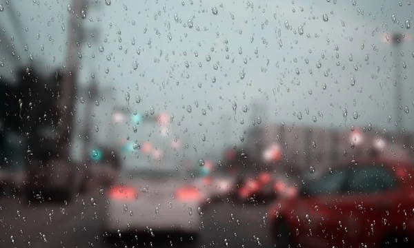 Traffic jams in the rain, shot through wet glass — Stock Photo, Image