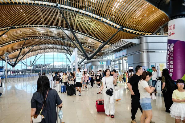 The Hong KongZhuhaiMacau Bridge (HZMB) Hong Kong Port, Hong Kong- 17 May 2025: the deaparture hall right before custom for leaving Hong Kong with busy crowd holding luggage