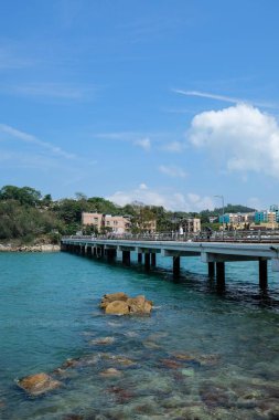 Peng Chau, Lantau Island, Hong Kong- 20 Apr 2025:the bridge connecting Peng Chau and Tai Lei Island in the blue sea with blue sky