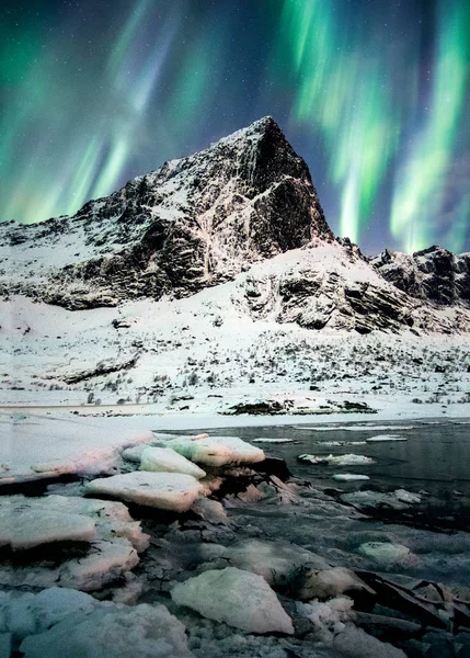 Aurora Borealis (Northern lights) explosion over mountains in glacier at Lofoten islands, Norway