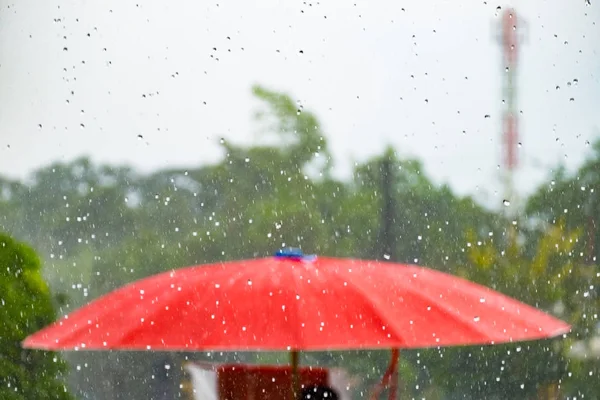 Red umbrella with storm fall rain — Stock Photo, Image