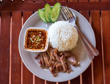 Ahşap masa üzerinde pirinç yasemin ile ızgara dilimlenmiş domuz