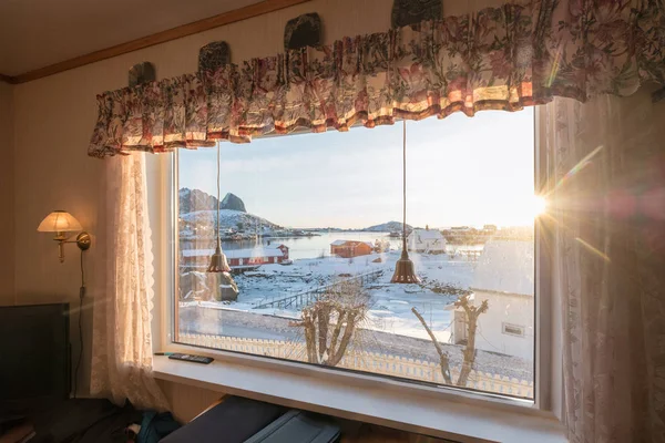 View of window with sunshine through curtain in winter