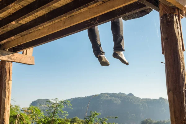 Tourist man sitting legs hanging on terrace