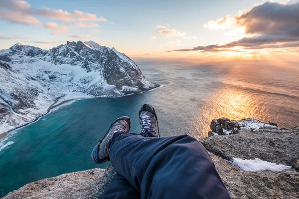 Man hiker cross legs sitting on peak mountain with coastline at