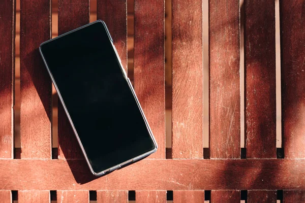 Smartphone blank display put on wooden table