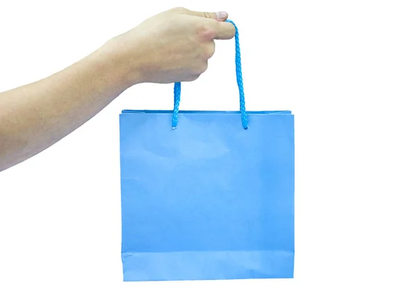 Alcance de mano bolsa de papel azul sobre fondo —  Fotos de Stock