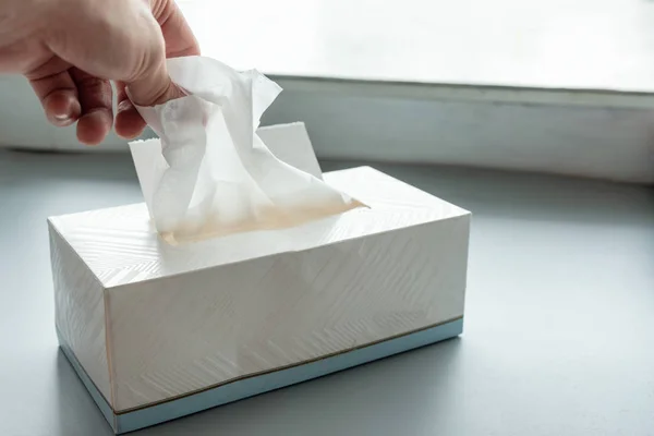 Hand picking white tissue paper — Stock Photo, Image