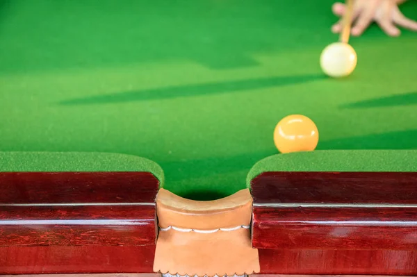 Man's hand playing snooker in bar with snooker ball — Stock Photo, Image