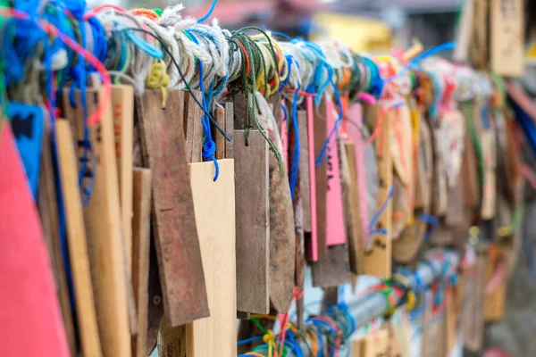 Plate wood hanging colorful thread on rail of traditional Stock Image