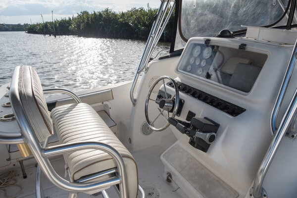 White yacht control panel with steering wheel