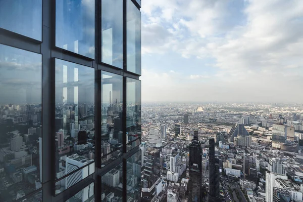 Modern glass building with crowded building in bangkok