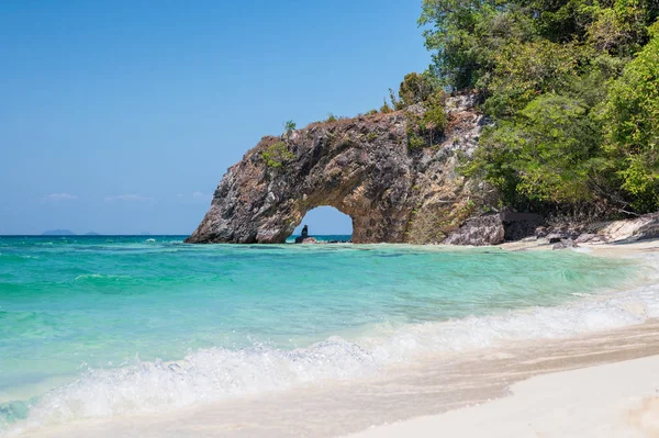 Arch natural rock on turquoise sea and the beach