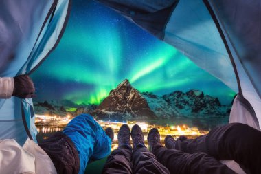 Group of climber are inside camping with aurora borealis over mo clipart