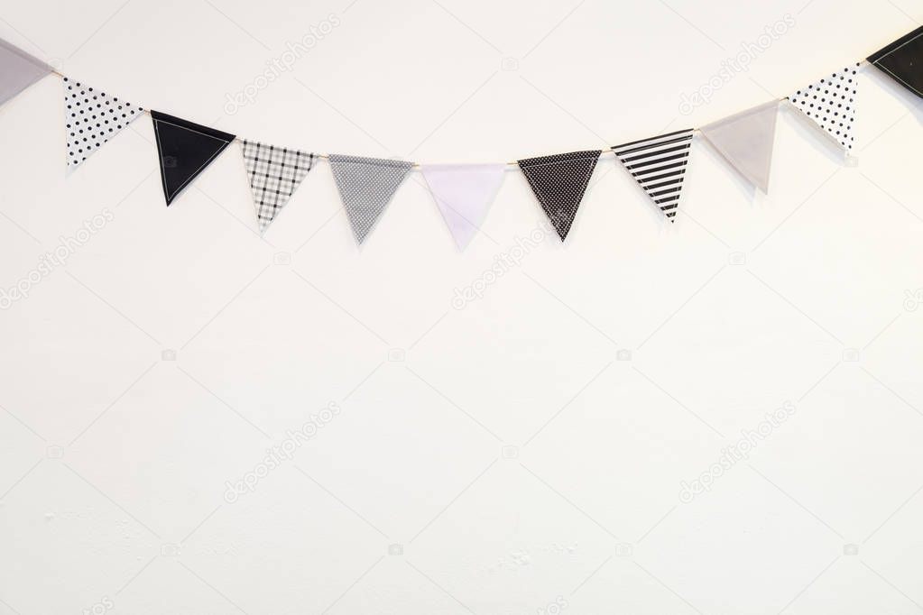 Small black white triangle shape flag hanging curve down plaster